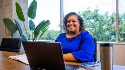 Durham Research Collectives Owner sitting behind a desk